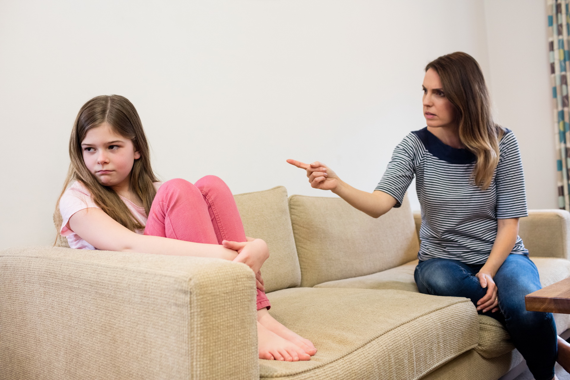 Daughter ignoring her mother after an argument in living room